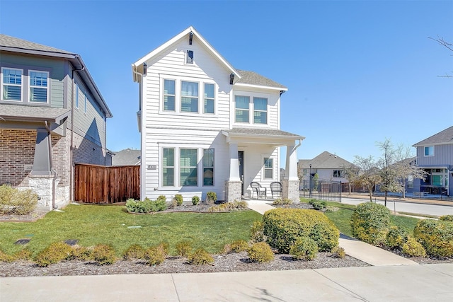 view of front of property with a front yard and fence