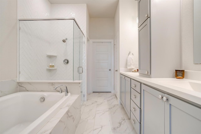 bathroom featuring double vanity, a bath, marble finish floor, a shower stall, and a sink