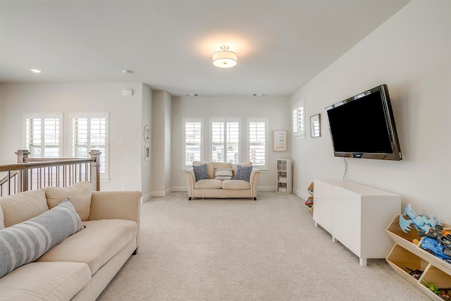 living room with light carpet, recessed lighting, and baseboards