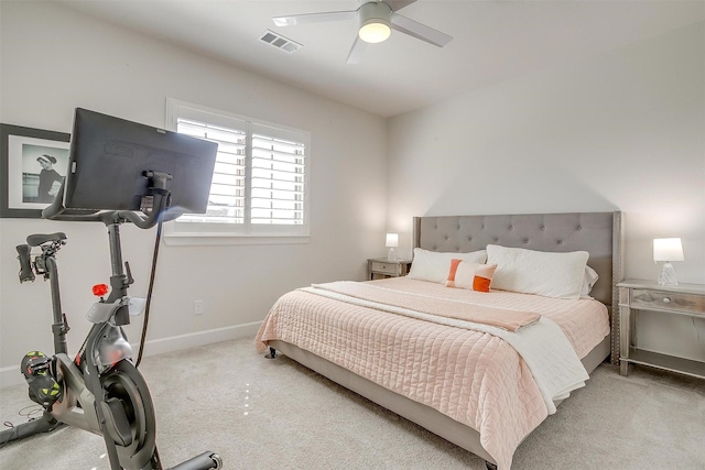 carpeted bedroom featuring ceiling fan, visible vents, and baseboards