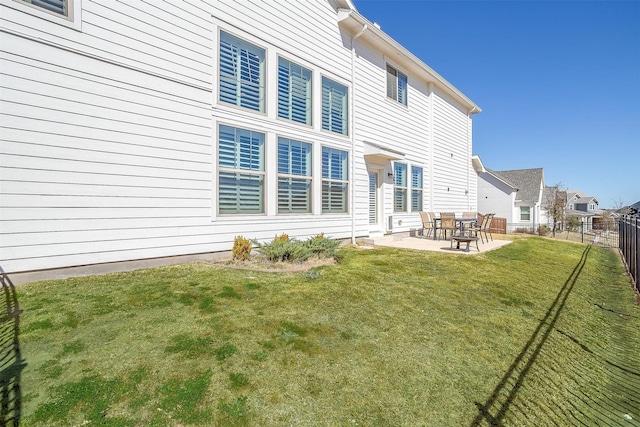 rear view of property featuring a fenced backyard, a patio, and a lawn