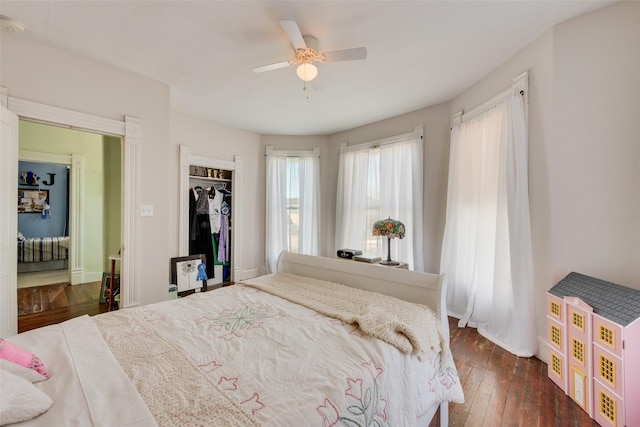 bedroom featuring a closet, dark wood finished floors, and ceiling fan