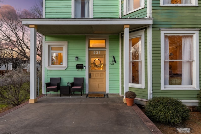 exterior entry at dusk with covered porch