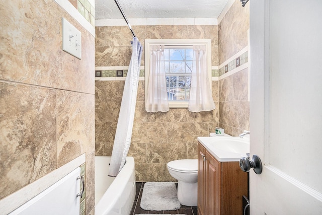 full bathroom with toilet, shower / tub combo with curtain, vanity, and tile walls