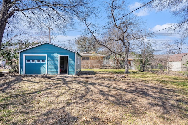 detached garage featuring fence