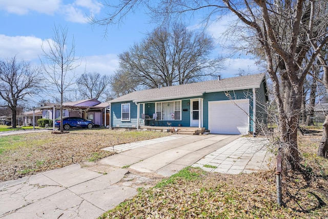 ranch-style home featuring driveway, a porch, and an attached garage