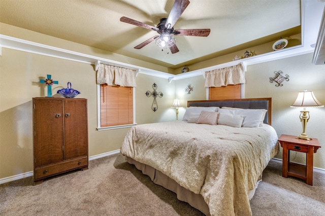 carpeted bedroom with baseboards and a ceiling fan