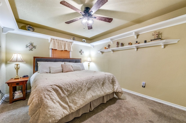 carpeted bedroom with ceiling fan and baseboards