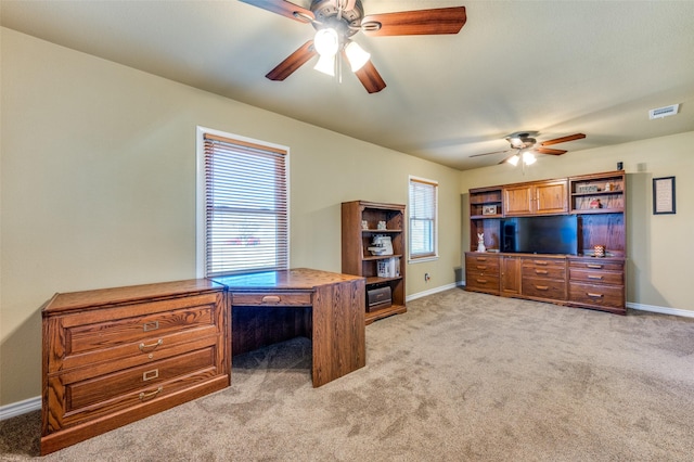 office area with light carpet, baseboards, visible vents, and a ceiling fan