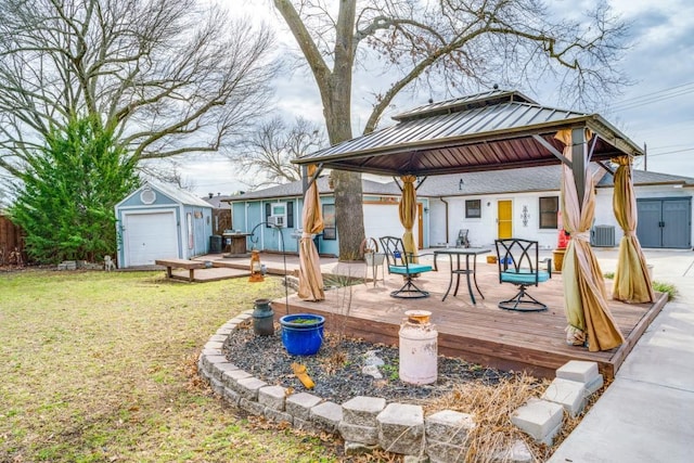 exterior space with a gazebo, a storage unit, a lawn, and an outdoor structure