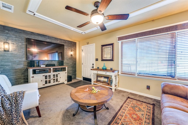 living area with carpet floors, a glass covered fireplace, visible vents, and plenty of natural light