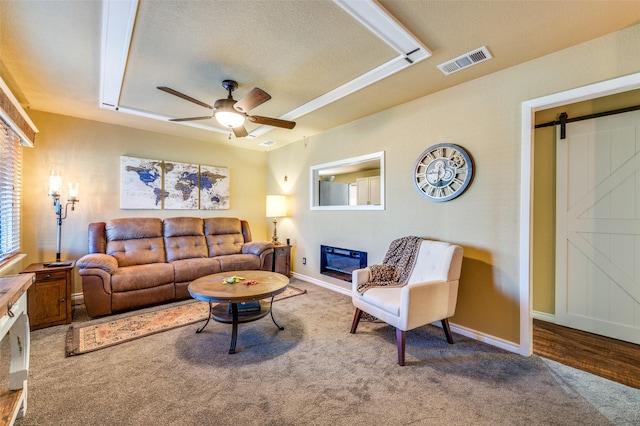 107 S Graves St, Mckinney, TX 75069 - living area featuring a barn door, carpet flooring, a ceiling fan, baseboards, and a textured ceiling