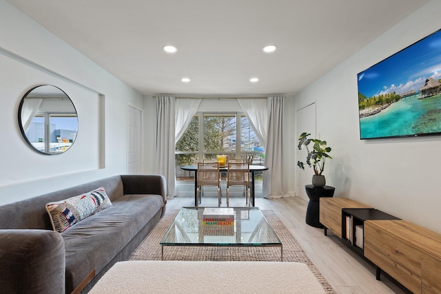 living room with light wood-style flooring and recessed lighting