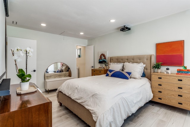 bedroom featuring light wood-type flooring, attic access, and recessed lighting