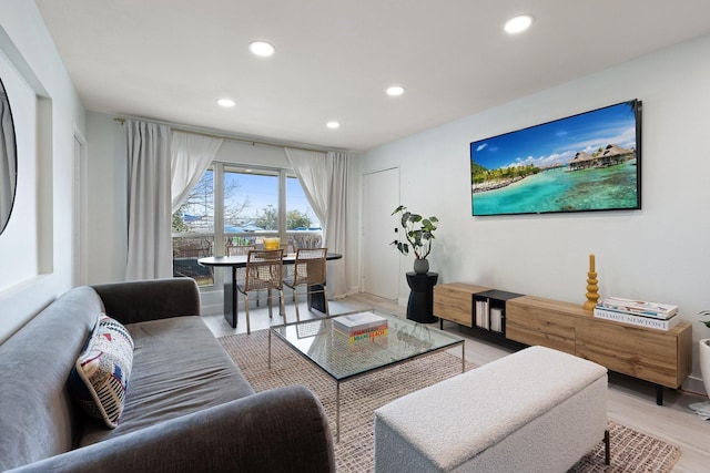 living room featuring light wood-type flooring and recessed lighting