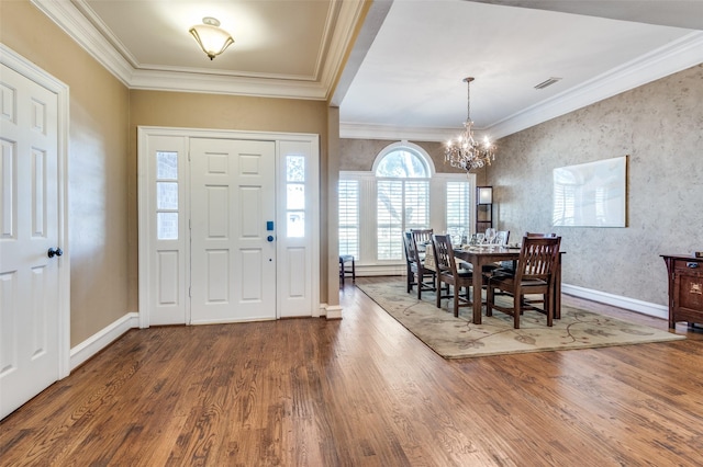 foyer entrance featuring ornamental molding, wood finished floors, and visible vents