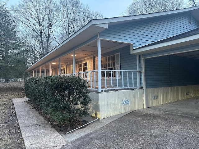 view of home's exterior with covered porch and crawl space