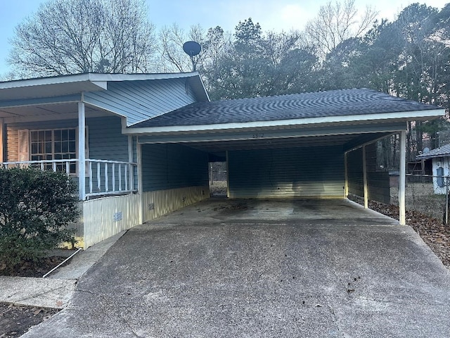 exterior space with aphalt driveway and an attached carport