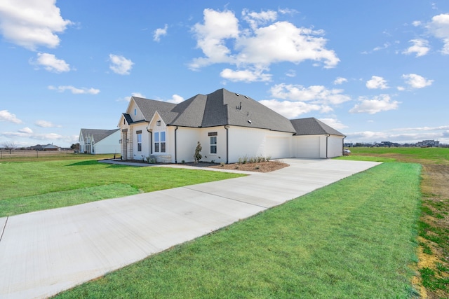 view of front of house with an attached garage, concrete driveway, a shingled roof, and a front yard