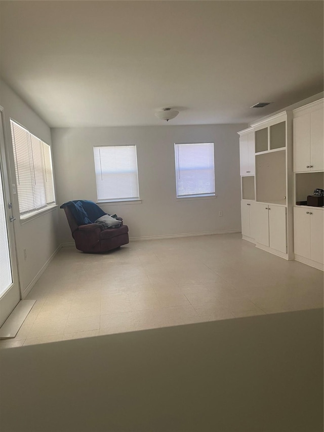 interior space with visible vents, baseboards, and a healthy amount of sunlight