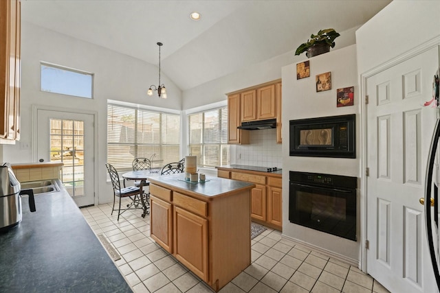 kitchen featuring black appliances, light tile patterned floors, under cabinet range hood, and vaulted ceiling