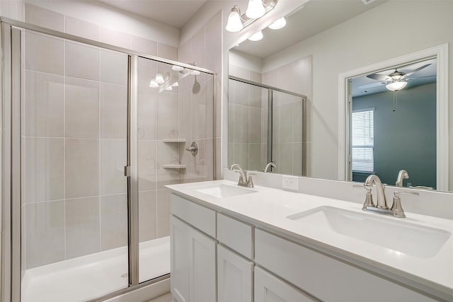 bathroom featuring a stall shower and a sink