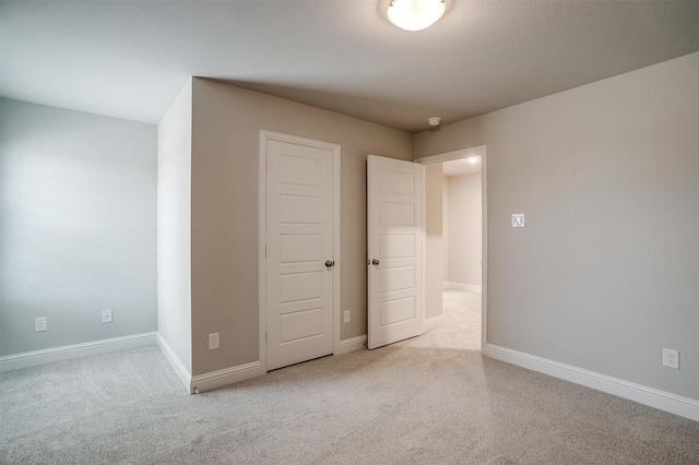 unfurnished bedroom featuring baseboards and carpet flooring