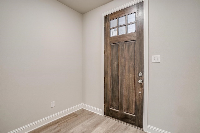 entryway with light wood-type flooring and baseboards