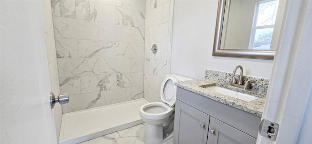 bathroom with a stall shower, marble finish floor, vanity, and toilet