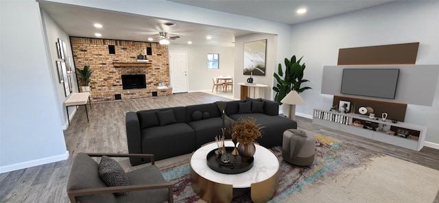 living area featuring a brick fireplace, baseboards, and wood finished floors