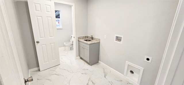 laundry room with cabinet space, marble finish floor, electric dryer hookup, washer hookup, and a sink