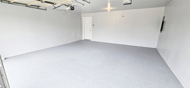 garage featuring baseboards and a garage door opener