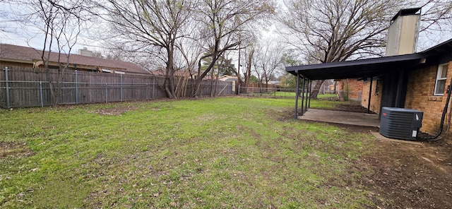 view of yard featuring a fenced backyard and central AC