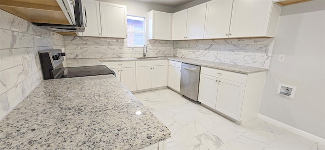 kitchen featuring light stone counters, stainless steel appliances, a sink, marble finish floor, and decorative backsplash