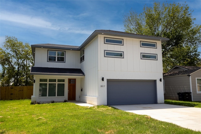 view of front of house with an attached garage, board and batten siding, fence, driveway, and a front lawn