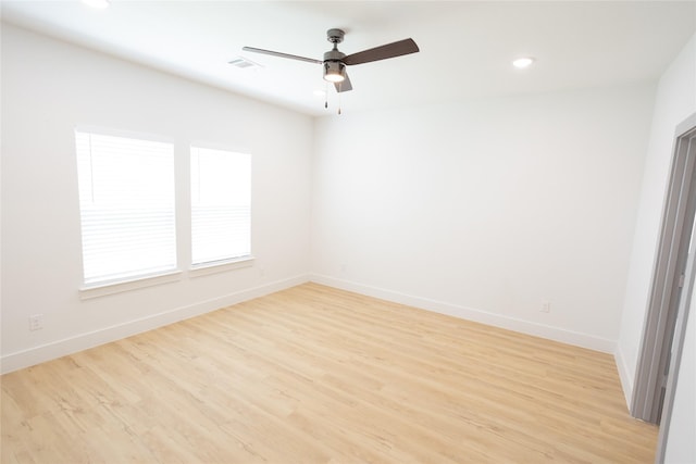 spare room with baseboards, visible vents, ceiling fan, light wood-style floors, and recessed lighting