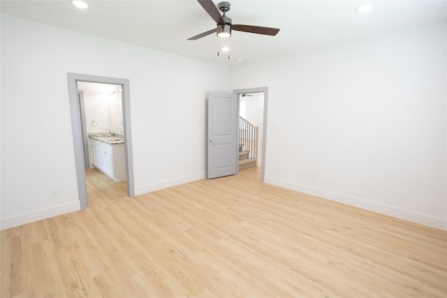 unfurnished bedroom with recessed lighting, light wood-style flooring, and baseboards