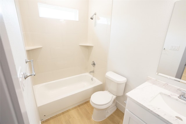 bathroom with toilet, bathtub / shower combination, wood finished floors, and vanity