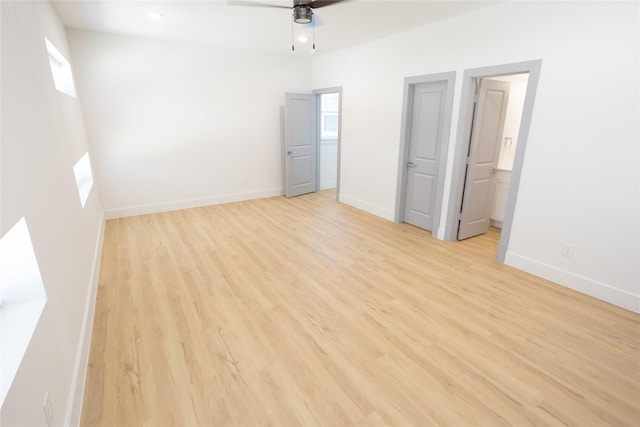 interior space featuring ensuite bathroom, recessed lighting, a ceiling fan, baseboards, and light wood finished floors