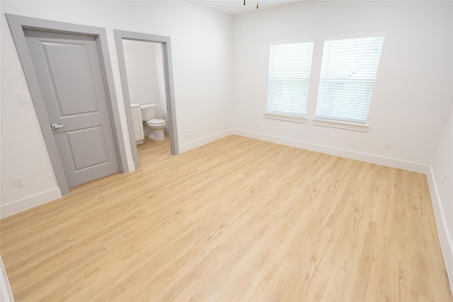 unfurnished room featuring light wood-style flooring and baseboards