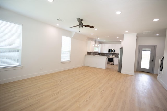 unfurnished living room with visible vents, plenty of natural light, light wood-style flooring, and recessed lighting