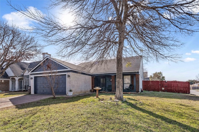 view of front of house featuring driveway, an attached garage, fence, a front lawn, and brick siding