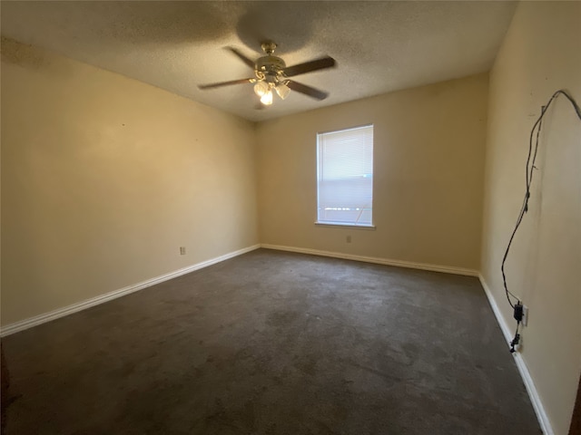 unfurnished room with a textured ceiling, dark colored carpet, a ceiling fan, and baseboards