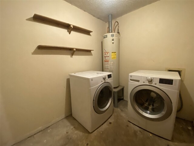 washroom with water heater, laundry area, a textured ceiling, and independent washer and dryer