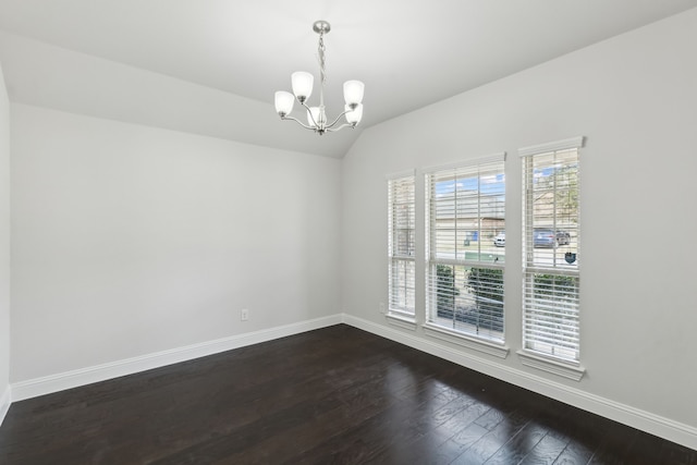 spare room with lofted ceiling, baseboards, a chandelier, and dark wood-type flooring