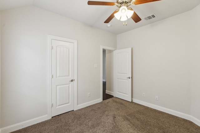 unfurnished bedroom with ceiling fan, carpet floors, visible vents, baseboards, and vaulted ceiling