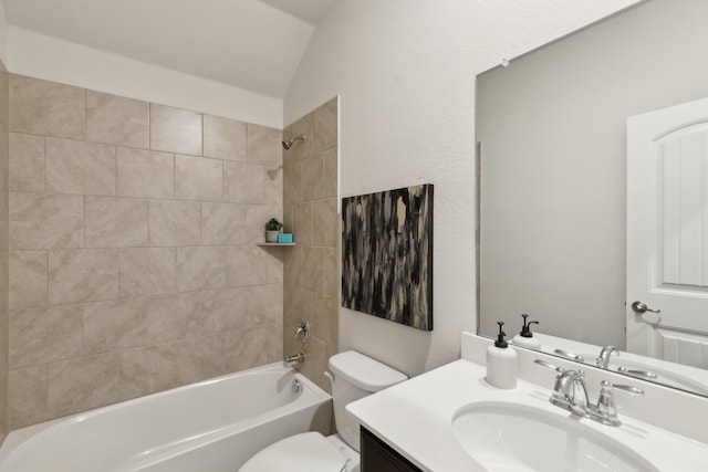 full bathroom with  shower combination, vaulted ceiling, vanity, and toilet