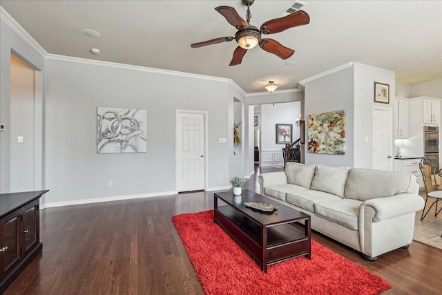 living room with dark wood-style flooring, crown molding, visible vents, a ceiling fan, and baseboards