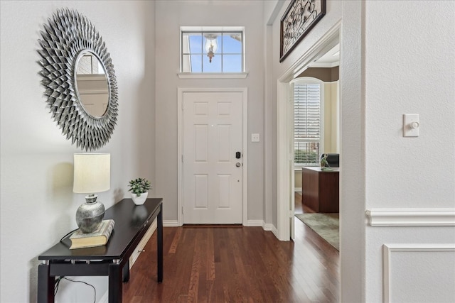 foyer featuring dark wood-style flooring and baseboards