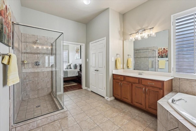 bathroom featuring tile patterned floors, a shower stall, a bath, and vanity